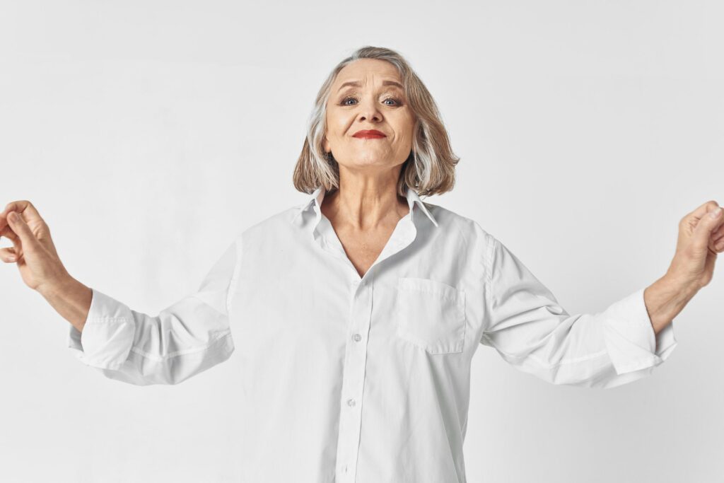cheerful elderly woman in white shirt emotions studio lifestyle