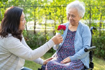 Caregiver daughter hug and help Asian elderly Caregiver daughter hug and help Asian elderly