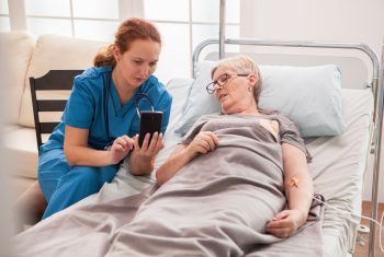 Female doctor helping senior woman in nursing home Female doctor helping senior woman in nursing home