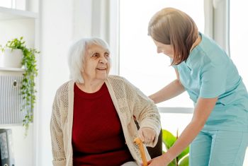 Nurse Assists Elderly Woman Nurse Assists Elderly Woman